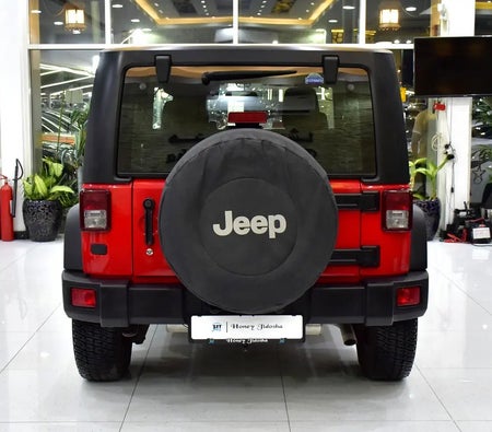 Красный Jeep Wrangler Sport 2017 год