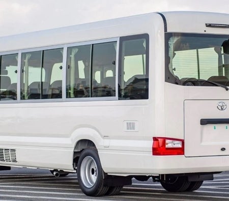 White Toyota Coaster 2024