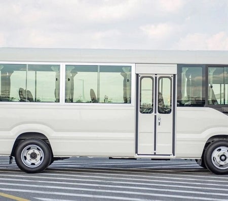 White Toyota Coaster 2024