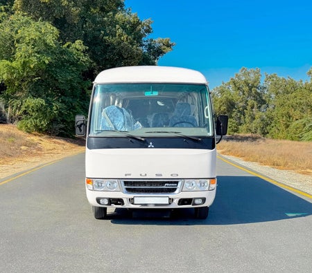 White Toyota Coaster 2024