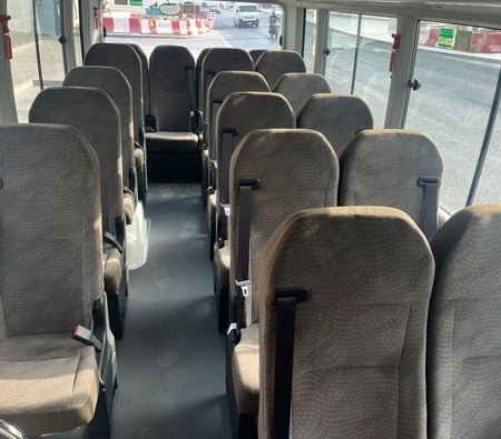 White Toyota Coaster 2025