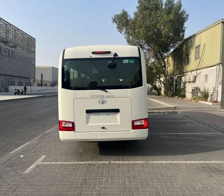 White Toyota Coaster 2025