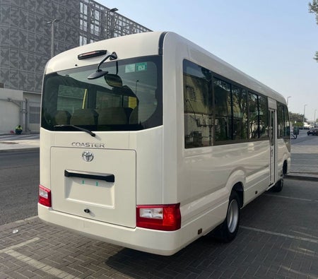 White Toyota Coaster 2025