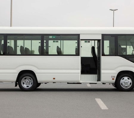 White Toyota Coaster 2025