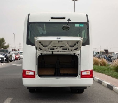 White Toyota Coaster 2025