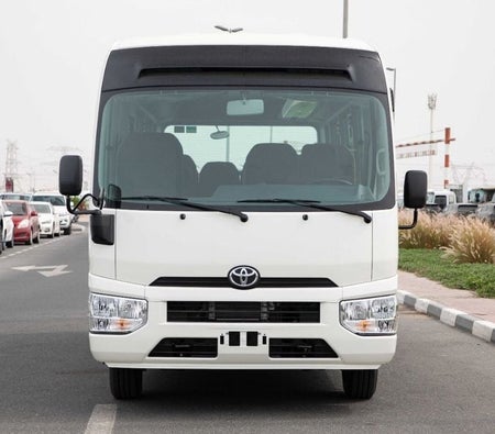 White Toyota Coaster 2025