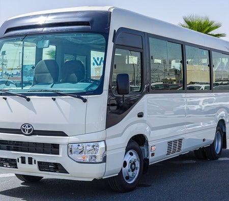 White Toyota Coaster 2026