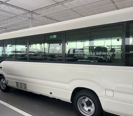 White Toyota Coaster 2026