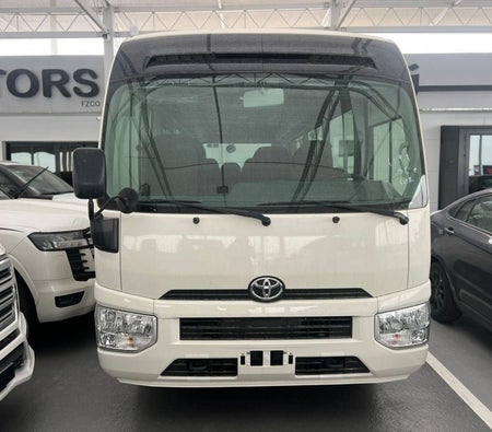 White Toyota Coaster 2026