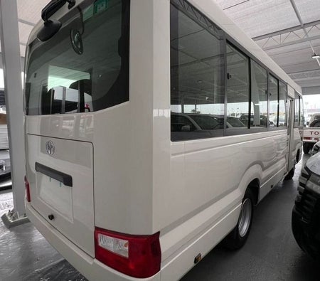 White Toyota Coaster 2026