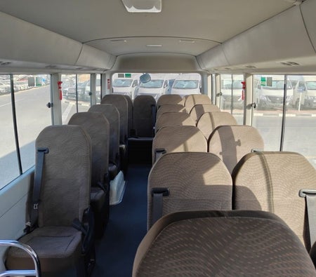 White Toyota Coaster 2026