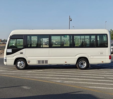 White Toyota Coaster 2026