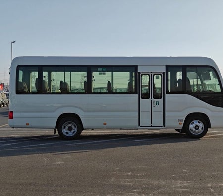 White Toyota Coaster 2026